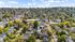 Breathtaking aerial view of a vibrant neighborhood surrounded by lush greenery and charming homes, showcasing a serene residential community.