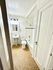 Bright and inviting bathroom featuring elegant lighting, a sleek pedestal sink, and a classic bathtub for ultimate relaxation.