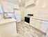 Bright, modern kitchen with elegant white cabinetry, sleek countertops, and state-of-the-art appliances.