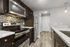 Modern kitchen with sleek stainless steel appliances, stylish tile backsplash, and elegant wood flooring for a contemporary touch.