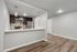 Modern kitchen with sleek stainless steel appliances, elegant dark cabinetry, and chic pendant lighting, perfect for contemporary living.