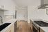 Modern kitchen with sleek design, featuring stainless steel appliances, elegant cabinetry, and a spacious countertop.