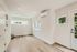 Bright and airy room with elegant wooden flooring, modern recessed lighting, and large windows for natural light.