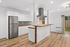 Modern kitchen with sleek stainless steel fridge, white cabinetry, and inviting wooden countertops, featuring hardwood floors and ample natural light.