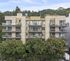 Modern apartment building with spacious balconies and lush green surroundings, offering a perfect urban living experience.