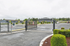 Secure and welcoming apartment complex entry with well-maintained landscaping and modern fencing, offering a peaceful residential environment.
