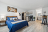 Modern studio apartment with cozy bed, chic kitchenette, and stylish decor, offering an inviting and functional living space.