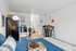 Modern studio apartment with cozy sofa, stylish bar seating, and sleek kitchen, perfect for urban living.