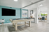 Modern entertainment room with a sleek pool table, large flat-screen TV, and stylish decor, leading to a bright office area with large windows.
