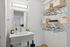 Chic bathroom with modern vanity, spacious shelves for storage, and cozy ambiance.