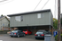 Modern two-story apartment with covered parking and sleek exterior design, perfect for urban living.