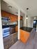 Modern kitchen with stainless steel appliances, sleek granite countertops, and warm wooden cabinetry, offering a blend of functionality and style.