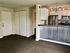 Modern open-concept kitchen with sleek appliances, corrugated metal breakfast bar, and inviting warm tones, perfect for stylish living.