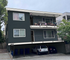 Charming multi-story apartment building with spacious balconies and convenient covered parking.