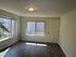 Bright and inviting living space with large windows and modern lighting, perfect for a cozy retreat.