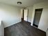 Modern and inviting bedroom with sleek wood flooring, ample natural light, and spacious closet.
