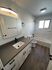 Contemporary bathroom with sleek vanity, modern fixtures, and elegant wood flooring.