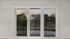 Bright and airy apartment view with sliding glass doors leading to a charming balcony overlooking urban scenery.