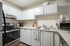 Modern kitchen with sleek stainless steel appliances, abundant white cabinetry, and ample countertop space perfect for culinary creativity.