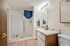 Modern bathroom featuring a sleek vanity, spacious glass shower, and bright vanity lighting for a refreshing feel.