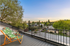 Charming balcony with comfortable deck chairs overlooking a serene neighborhood, perfect for relaxing and enjoying stunning sunset views.