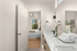 Bright and elegant bathroom leading to a serene bedroom with modern fixtures and nature views.