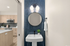 Contemporary apartment interior showcasing a sleek kitchen with modern appliances and a chic bathroom with stylish blue tile accents.