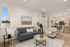 Chic and inviting open-concept living area with modern furnishings, cozy seating, and a stylish kitchen in a bright, airy apartment.