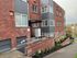Charming red brick apartment building with modern accents, featuring well-maintained landscaping and convenient entryway.