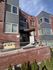 Charming apartment building with modern brick fa&ccedil;ade, large windows, and inviting entrance at 2424.