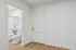 Modern apartment entry with elegant white door and sleek bathroom featuring gold fixtures.