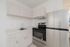 Modern kitchen with sleek stainless steel appliances and elegant light wood cabinetry.