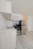Modern kitchen with sleek stainless steel appliances, elegant light wood cabinets, and chic countertops, offering a stylish cooking space.