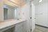 Bright and airy bathroom with a sleek vanity, elegant mirror, and modern fixtures.