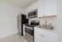 Sleek and modern kitchen with stainless steel appliances, white cabinetry, and elegant flooring.