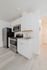 Modern kitchen with sleek cabinetry, stainless steel appliances, and elegant laminate flooring.
