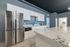 Sleek modern kitchen with stainless steel appliances, elegant white cabinetry, and a marble island countertop, creating a perfect blend of style and functionality.