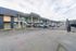 Modern apartment building with stylish facade and convenient parking area, offering a secure and inviting environment.