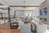 Elegant, spacious living room with modern decor, featuring sleek sofas, stylish coffee tables, and large windows letting in abundant natural light.