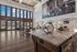 Luxurious modern apartment with high ceilings, grand windows, and elegant decor, offering a bright, spacious living area with a contemporary touch.