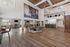 Luxurious open communal space featuring high ceilings, elegant lighting fixtures, cozy seating area, and modern bar counter, perfect for social gatherings.
