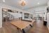 Chic, open-concept game room with modern lighting, featuring a ping pong table, pool table, and stylish seating area.