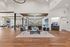 Elegant open-concept living space with sleek hardwood floors, modern furnishings, and stylish ceiling lighting.