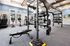Modern fitness center with state-of-the-art equipment including treadmills, exercise bikes, and strength training stations in a bright, spacious room.