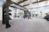 Spacious fitness center with modern exercise equipment, bright windows, and sleek design.