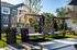 Chic outdoor lounge area with elegant cabanas and sun loungers, perfect for relaxation.