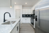 Modern kitchen with sleek stainless steel appliances, elegant granite countertops, and stylish white cabinetry.