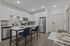 Modern kitchen with sleek white cabinets, stainless steel appliances, and elegant island seating, perfect for entertaining.