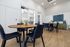 Modern dining area with elegant blue chairs, chic wooden table, and stylish decor, offering a contemporary feel.