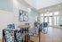 Bright and inviting modern lobby with geometric patterned chairs, abstract artwork, and natural light pouring through large windows.